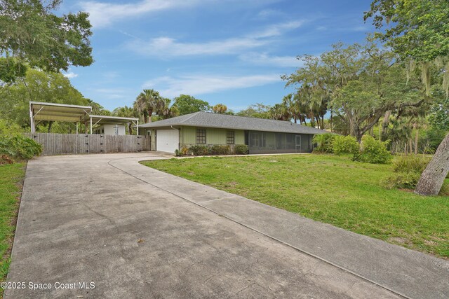 670 Kings Way, Merritt Island, FL 32953 - single story home with driveway, an attached garage, and a carport