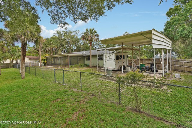 670 Kings Way, Merritt Island, FL 32953 - view of yard with a carport and a sunroom