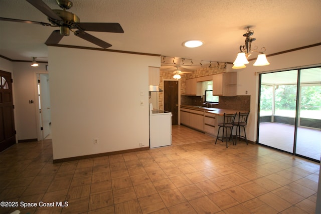 kitchen featuring decorative backsplash, open shelves, range, ornamental molding, and ceiling fan