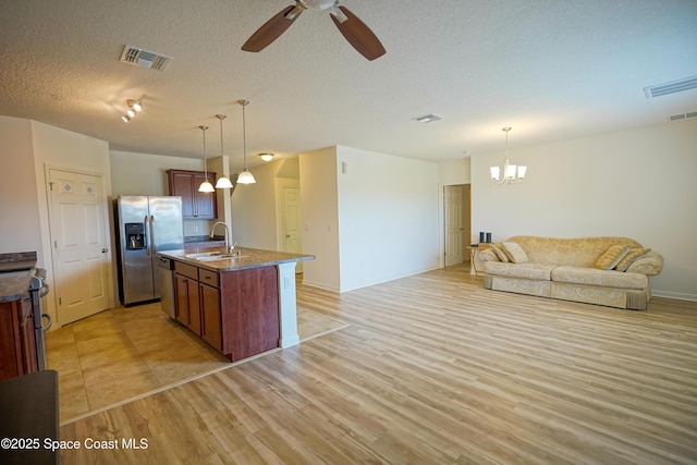 436 Great Falls Ln SW, Palm Bay, FL 32908 - kitchen featuring appliances with stainless steel finishes, light wood-type flooring, a sink, ceiling fan with notable chandelier, and open floor plan