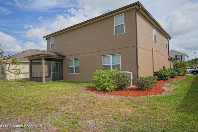 436 Great Falls Ln SW, Palm Bay, FL 32908 - rear view of house featuring fence, central AC, stucco siding, a sunroom, and a yard