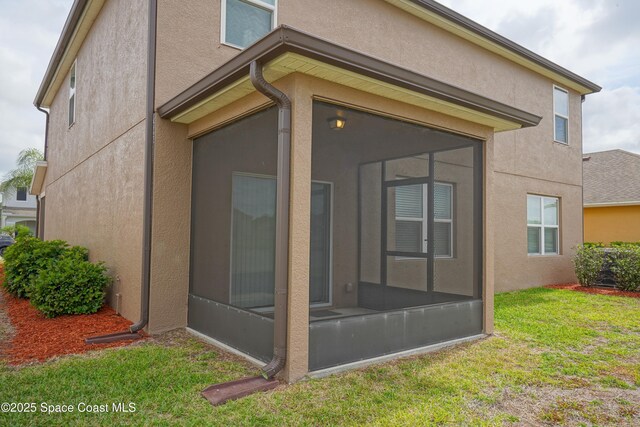 436 Great Falls Ln SW, Palm Bay, FL 32908 - view of property exterior featuring a yard, stucco siding, and a sunroom