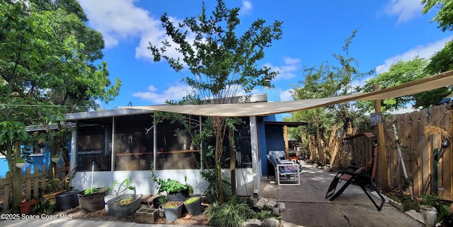 4805 Worth Ave, Titusville, FL 32780 - exterior space with fence, a sunroom, and a patio area