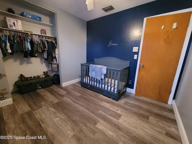 4805 Worth Ave, Titusville, FL 32780 - bedroom with baseboards, visible vents, wood finished floors, and a closet