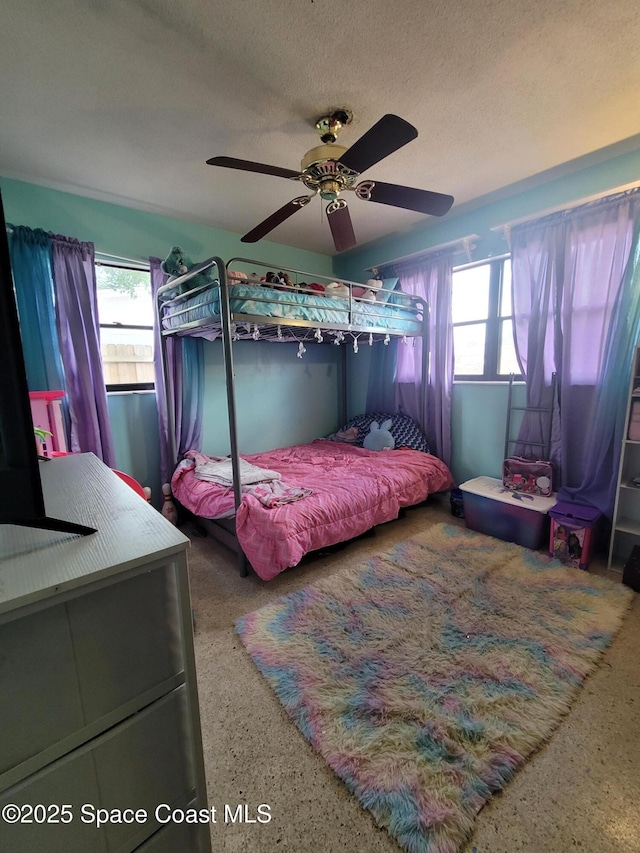 4805 Worth Ave, Titusville, FL 32780 - bedroom with a ceiling fan, a textured ceiling, multiple windows, and speckled floor