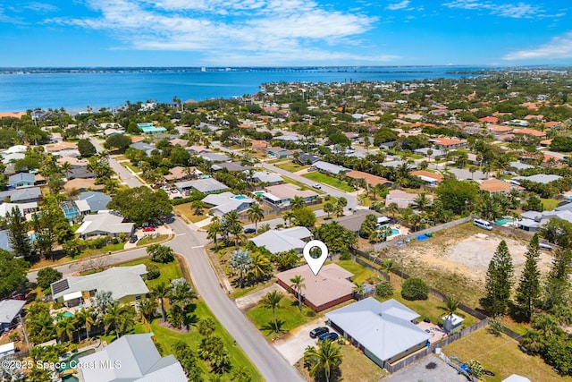 aerial perspective of suburban area featuring a nearby body of water