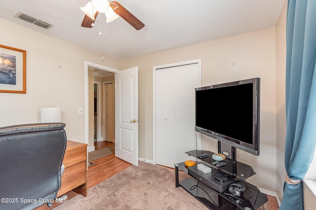 office area featuring visible vents, a ceiling fan, and baseboards