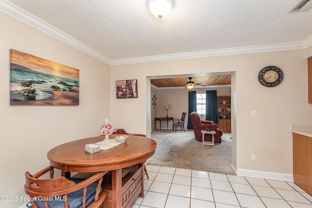 dining room with ceiling fan, visible vents, light tile patterned floors, ornamental molding, and light carpet
