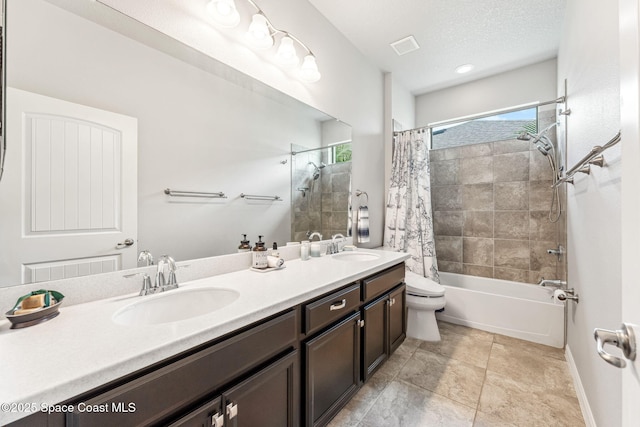 full bath with a sink, shower / bath combo, toilet, and double vanity