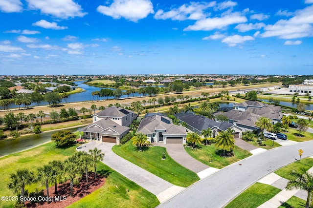drone / aerial view with a residential view and a water view