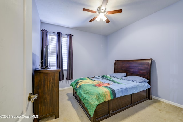 bedroom with baseboards, ceiling fan, and light carpet