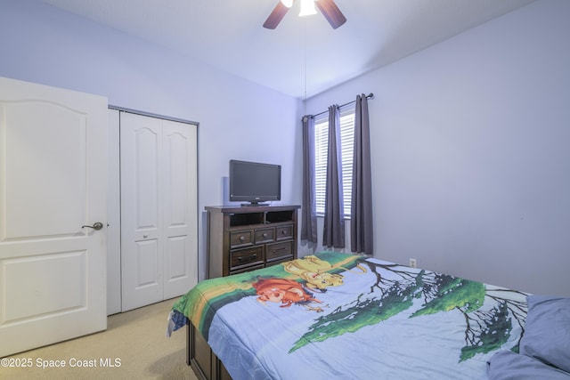 bedroom featuring ceiling fan, light carpet, and a closet
