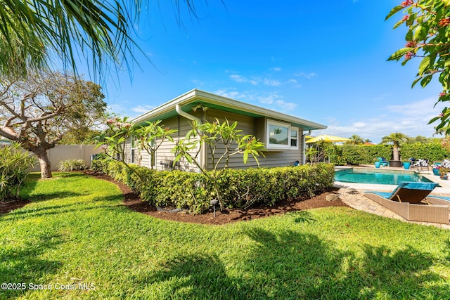 320 Amberjack Pl, Melbourne Beach, FL 32951 - view of side of home featuring a lawn, fence, and a fenced in pool