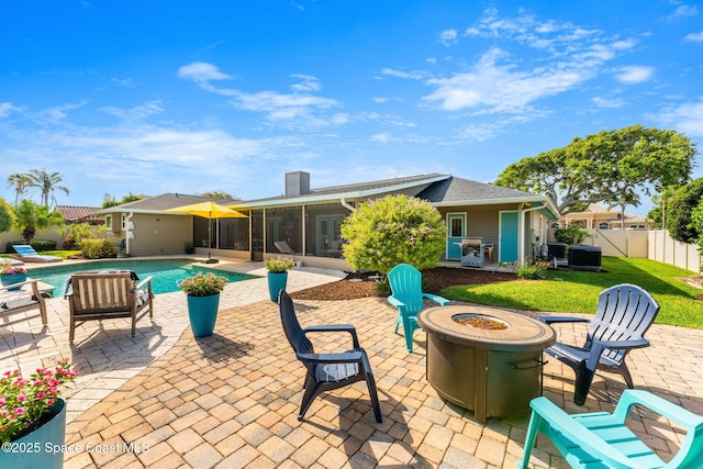 320 Amberjack Pl, Melbourne Beach, FL 32951 - exterior space featuring a fenced in pool, fence, a sunroom, and an outdoor fire pit
