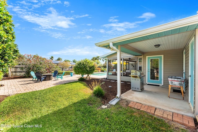 320 Amberjack Pl, Melbourne Beach, FL 32951 - view of yard with fence, a patio, a sunroom, and a fire pit