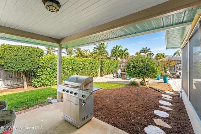 320 Amberjack Pl, Melbourne Beach, FL 32951 - view of patio featuring a fenced backyard and a grill