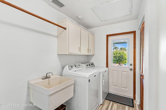 320 Amberjack Pl, Melbourne Beach, FL 32951 - laundry area featuring attic access, visible vents, cabinet space, a sink, and separate washer and dryer