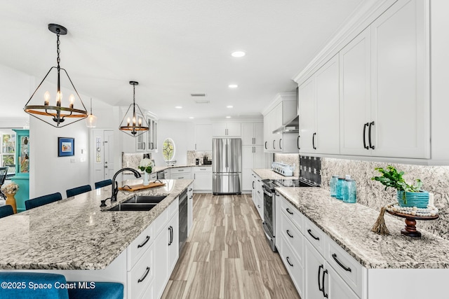 320 Amberjack Pl, Melbourne Beach, FL 32951 - kitchen with appliances with stainless steel finishes, tasteful backsplash, a sink, a chandelier, and white cabinetry