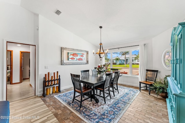320 Amberjack Pl, Melbourne Beach, FL 32951 - dining room with an inviting chandelier, baseboards, lofted ceiling, and visible vents