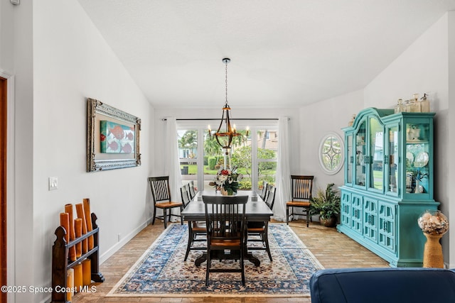 320 Amberjack Pl, Melbourne Beach, FL 32951 - dining room with baseboards, wood finished floors, and a chandelier