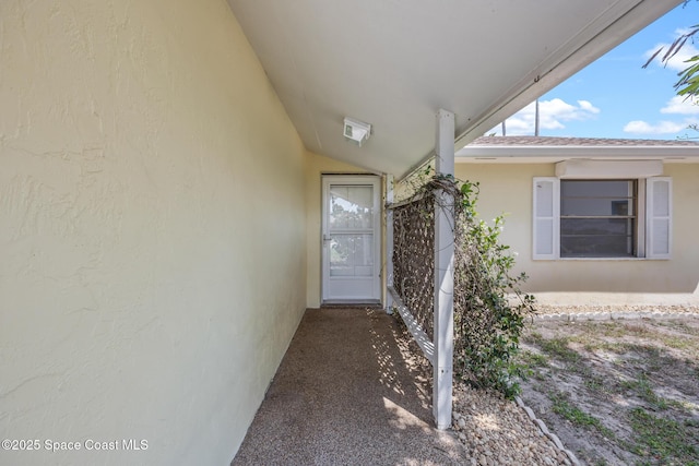 view of exterior entry with stucco siding