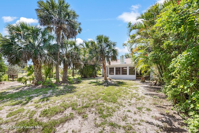view of yard with a sunroom