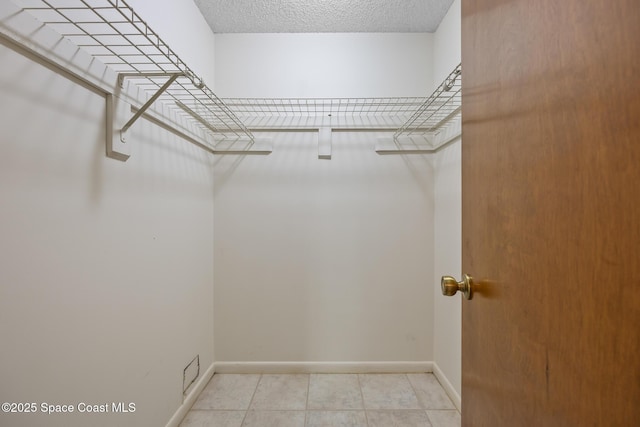 walk in closet featuring visible vents and light tile patterned floors