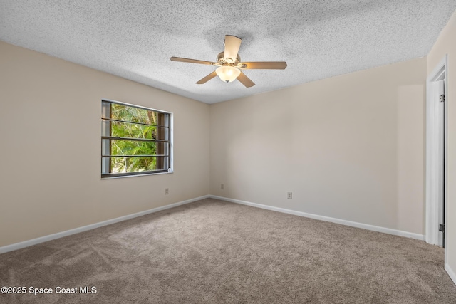carpeted empty room featuring a textured ceiling, a ceiling fan, and baseboards