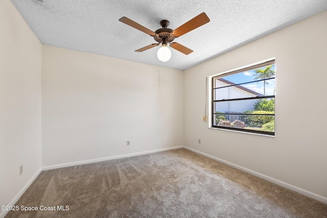 spare room with baseboards, a textured ceiling, and carpet flooring