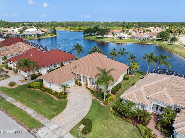 birds eye view of property with a water view and a residential view