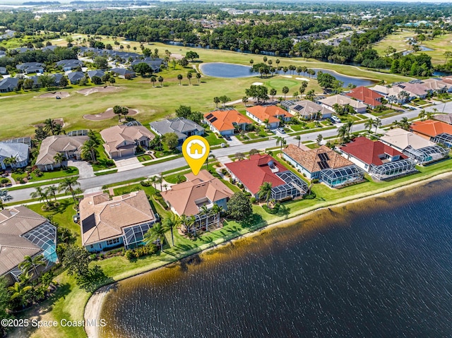 drone / aerial view with a water view, view of golf course, and a residential view