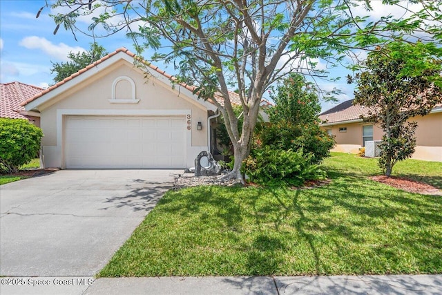 view of front of house featuring a tile roof, a front yard, stucco siding, concrete driveway, and an attached garage