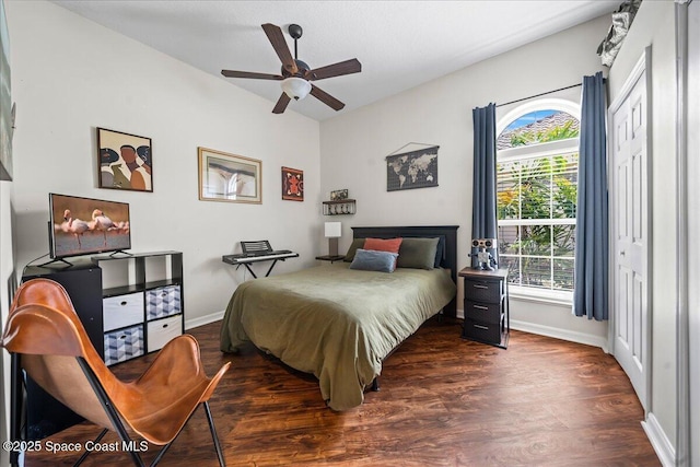 bedroom with dark wood finished floors, baseboards, and a ceiling fan