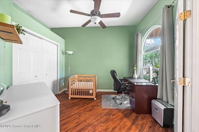 bedroom with a closet, a ceiling fan, wood finished floors, and baseboards