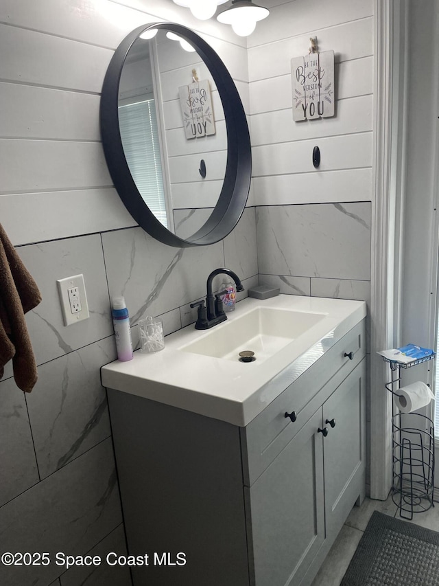 bathroom with marble finish floor and vanity