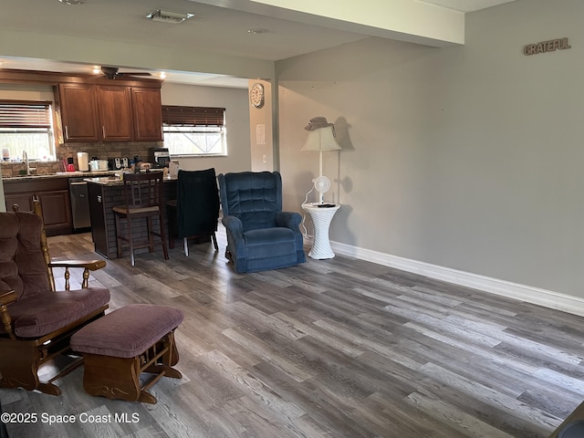 living room with baseboards, dark wood finished floors, and visible vents