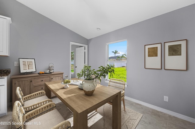 dining room with vaulted ceiling and baseboards