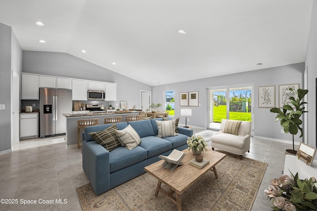 living room featuring light tile patterned floors, recessed lighting, vaulted ceiling, and baseboards
