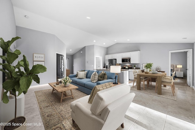 living area featuring recessed lighting and vaulted ceiling