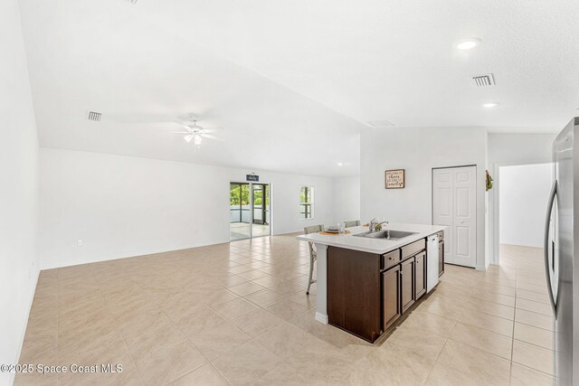 1591 Palatka Rd SE, Palm Bay, FL 32909 - kitchen featuring visible vents, freestanding refrigerator, dishwashing machine, a kitchen bar, and a sink