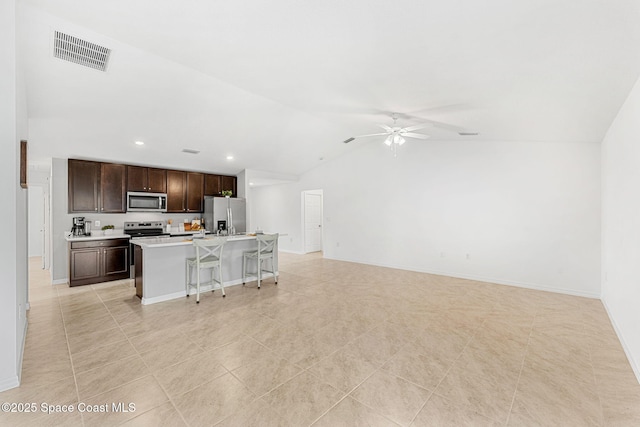 1591 Palatka Rd SE, Palm Bay, FL 32909 - living area with visible vents, a ceiling fan, baseboards, and vaulted ceiling