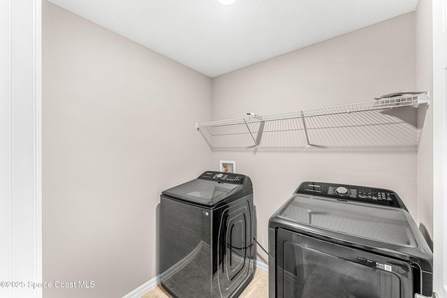1591 Palatka Rd SE, Palm Bay, FL 32909 - laundry area featuring baseboards, laundry area, and washer and clothes dryer