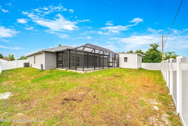 1591 Palatka Rd SE, Palm Bay, FL 32909 - view of yard with a fenced backyard, an outdoor structure, central AC, and a storage shed