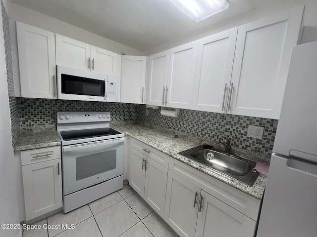 4841 NW 7th St Unit 203-4, Miami, FL 33126 - kitchen featuring white appliances, white cabinets, a sink, and tasteful backsplash