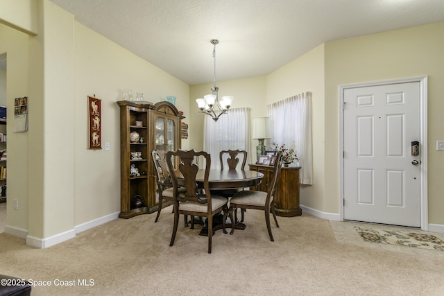 6008 Van Ness Dr, Melbourne, FL 32940 - dining room with a chandelier, baseboards, and light colored carpet