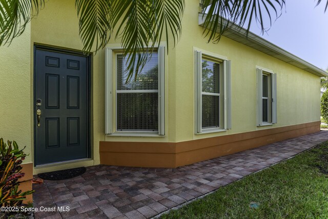 6008 Van Ness Dr, Melbourne, FL 32940 - view of side of property featuring stucco siding