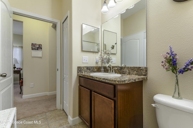 6008 Van Ness Dr, Melbourne, FL 32940 - bathroom featuring vanity, tile patterned flooring, baseboards, and toilet