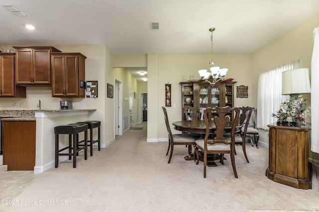 6008 Van Ness Dr, Melbourne, FL 32940 - dining space with visible vents, baseboards, light colored carpet, and an inviting chandelier