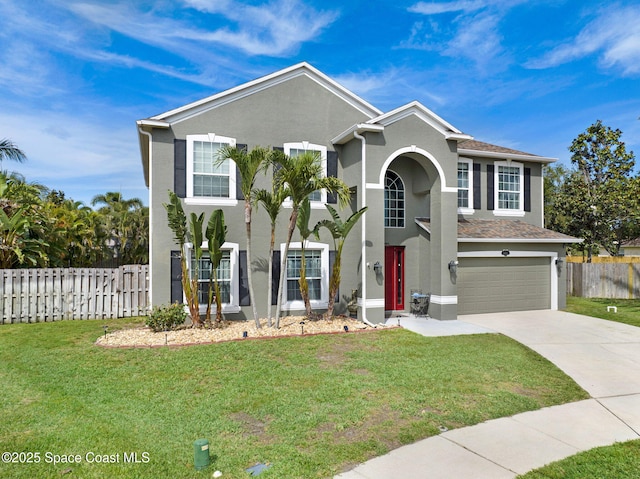 view of front of property with stucco siding, fence, driveway, a front lawn, and an attached garage