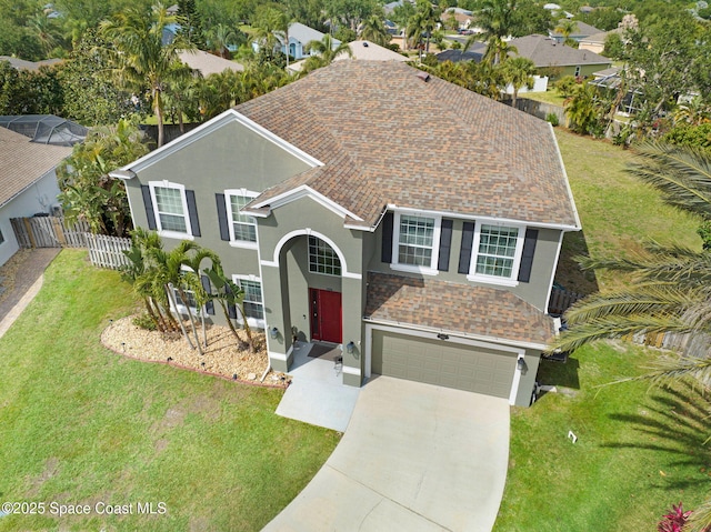 view of front of property featuring a front lawn, stucco siding, concrete driveway, an attached garage, and fence
